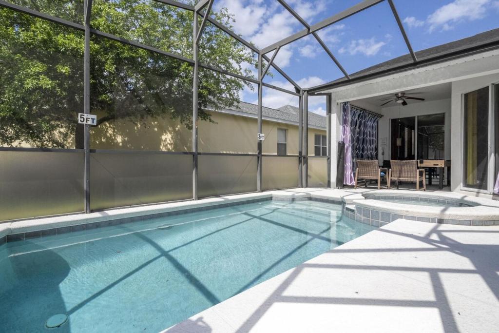 a swimming pool in a house at Cozy 4Bd Home Pool & Hot Tub at Trafalgar Resort in Kissimmee