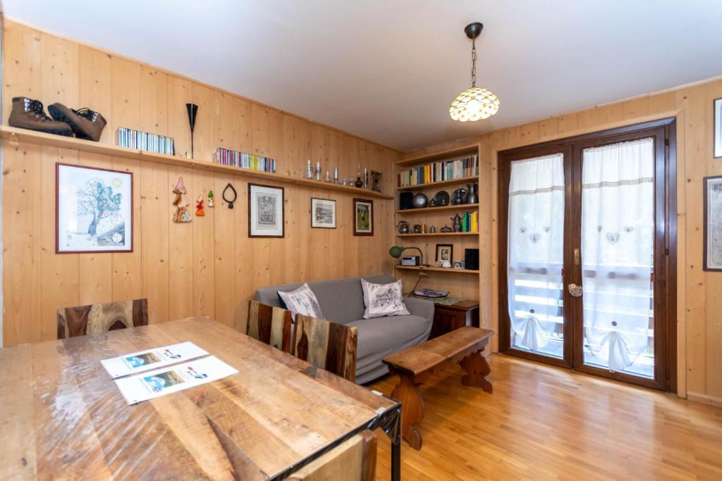 a living room with a table and a couch at Chalet Baranci in Pozza di Fassa