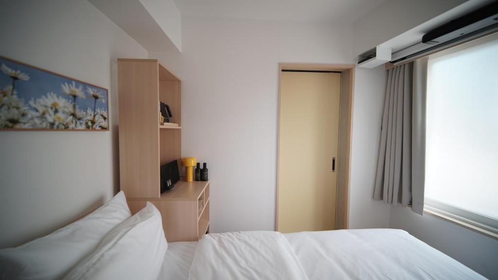Postel nebo postele na pokoji v ubytování Hotel Marguerite Seoul