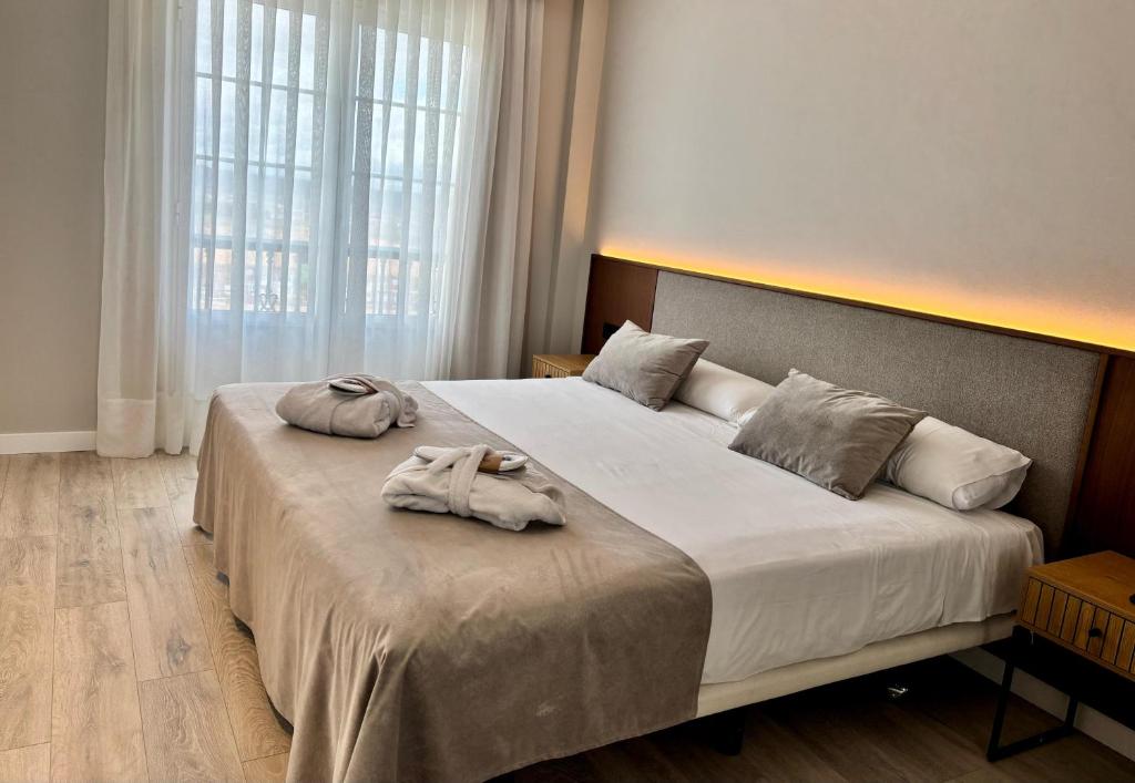 Postel nebo postele na pokoji v ubytování ARVA Santiago León