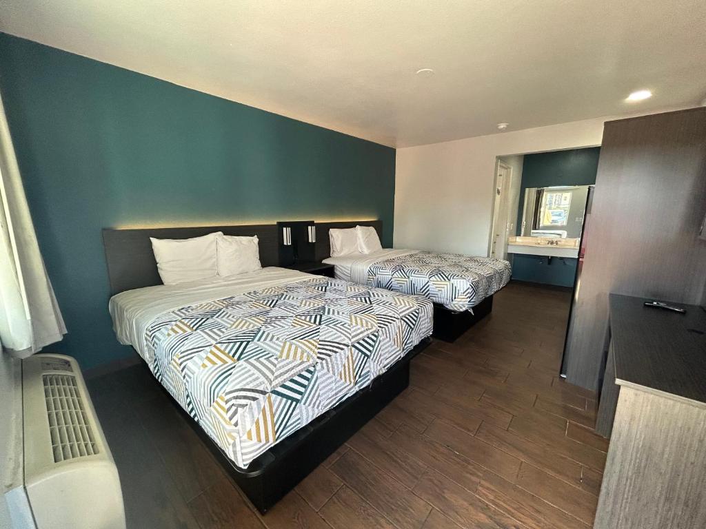 a hotel room with two beds and a window at Studio 6 Hemet, CA in Hemet