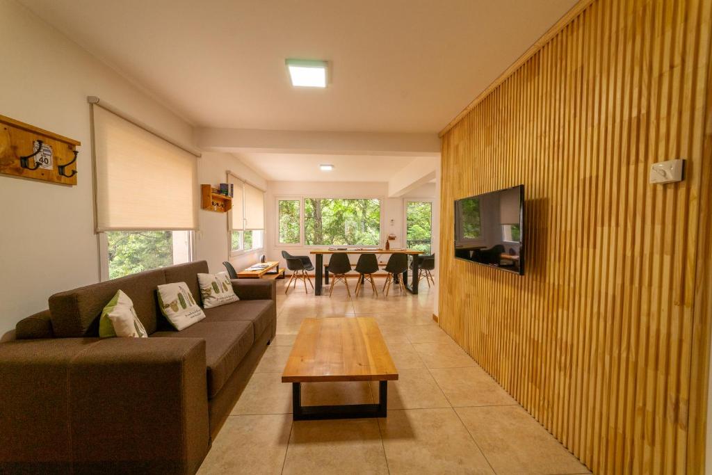 a living room with a couch and a table at Ventanas al Sur - Espacio Bandurrias - in San Martín de los Andes
