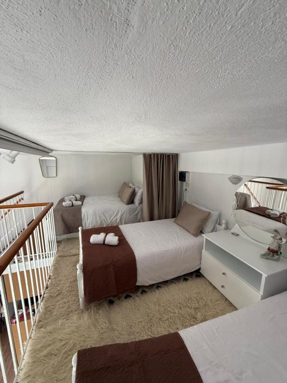 a hotel room with two beds and a staircase at Nature Paradise Apartment in Kardítsa