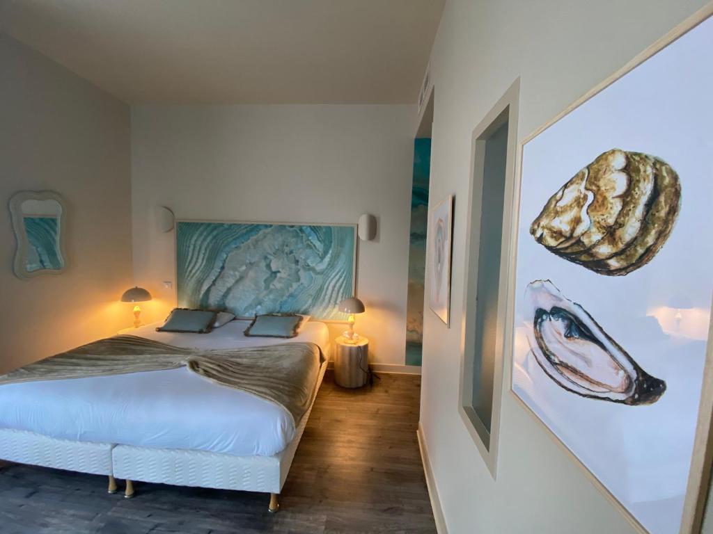 Postel nebo postele na pokoji v ubytování Hôtel De Paris