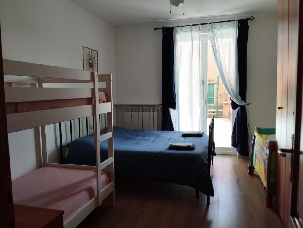 a bedroom with two bunk beds and a window at Il filo di Arianna in Albissola Marina