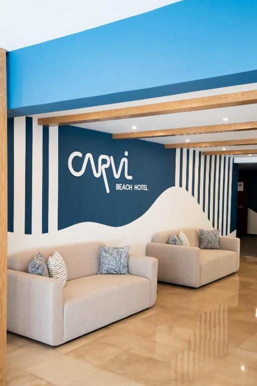 two couches in a room with a blue wall at Carvi Beach Hotel in Lagos