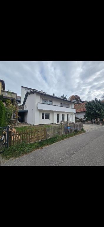 a white house on the side of a street at Ferienwohnungen Sonne in Siegsdorf