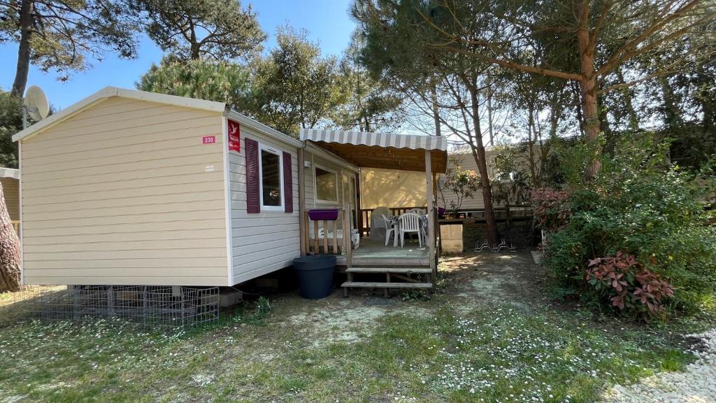 Petite maison blanche avec terrasse couverte dans l'établissement Mobilhome Trigano Samba 3 Bedrooms BA233 - La Palmyre Bonne Anse Plage, aux Mathes