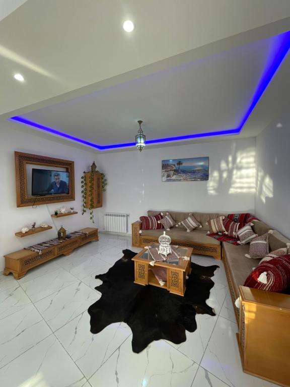 a living room with a couch and a table at The center of sidi bou said The Blue & White Perle 1 in Dar Mimoun Bey