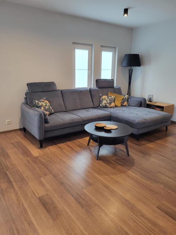 a living room with a couch and a coffee table at Saules māja in Gāršmuiža