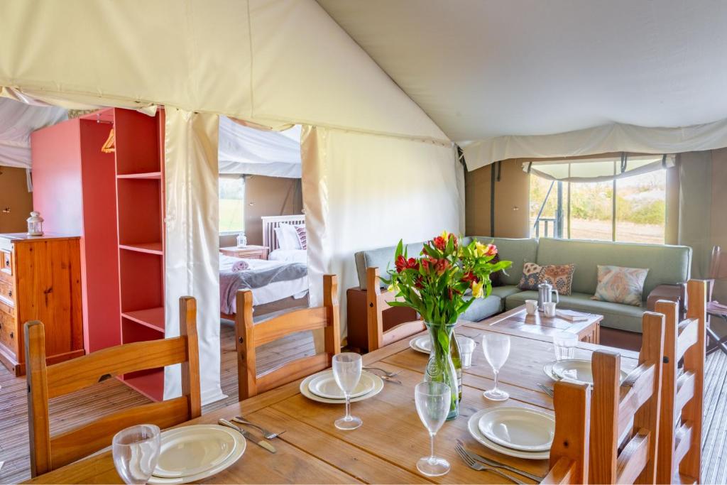 a dining room with a table in a tent at Kestrel - Sweffling Hall in Rendham