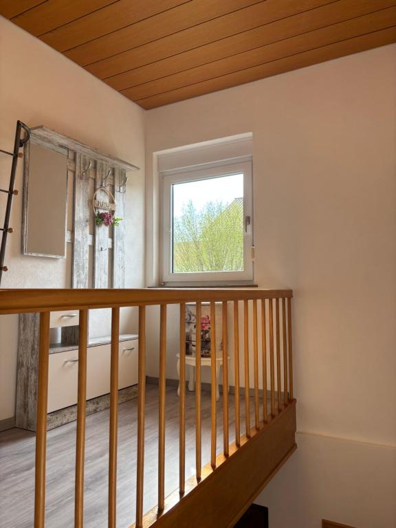 a room with a staircase with a window at Ferienwohnung an der Warte in Waldeck