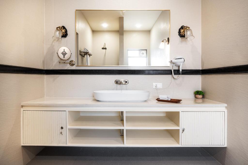 a bathroom with a sink and a mirror at Dera Jaipur Homestay in Jaipur