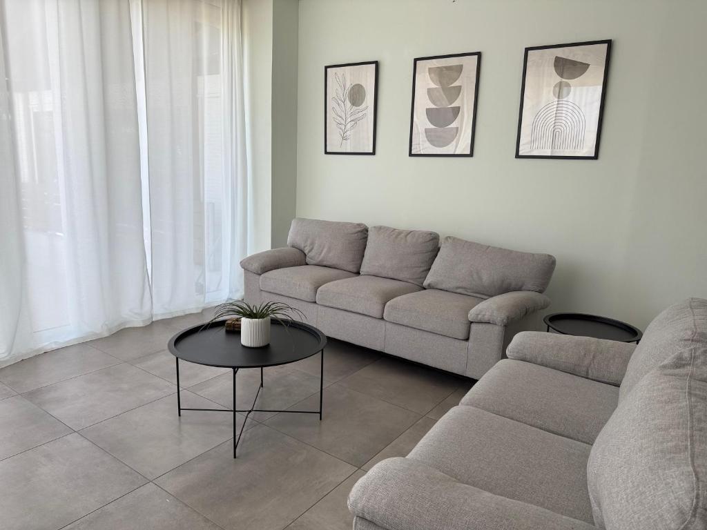 a living room with a couch and a table at Karamela Apartment in Kambánion
