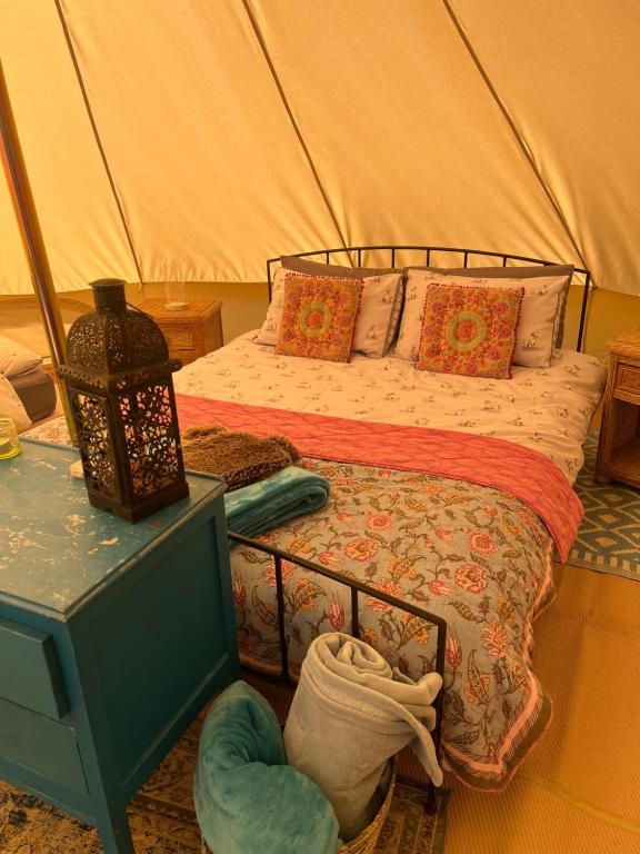 a bedroom with a bed in a tent at Swallows Oast Glamping in Sedlescombe