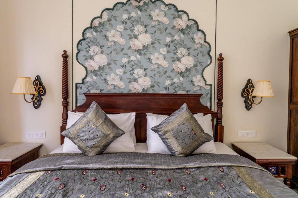 a bedroom with a large bed with a large headboard at Dera Jaipur Homestay in Jaipur