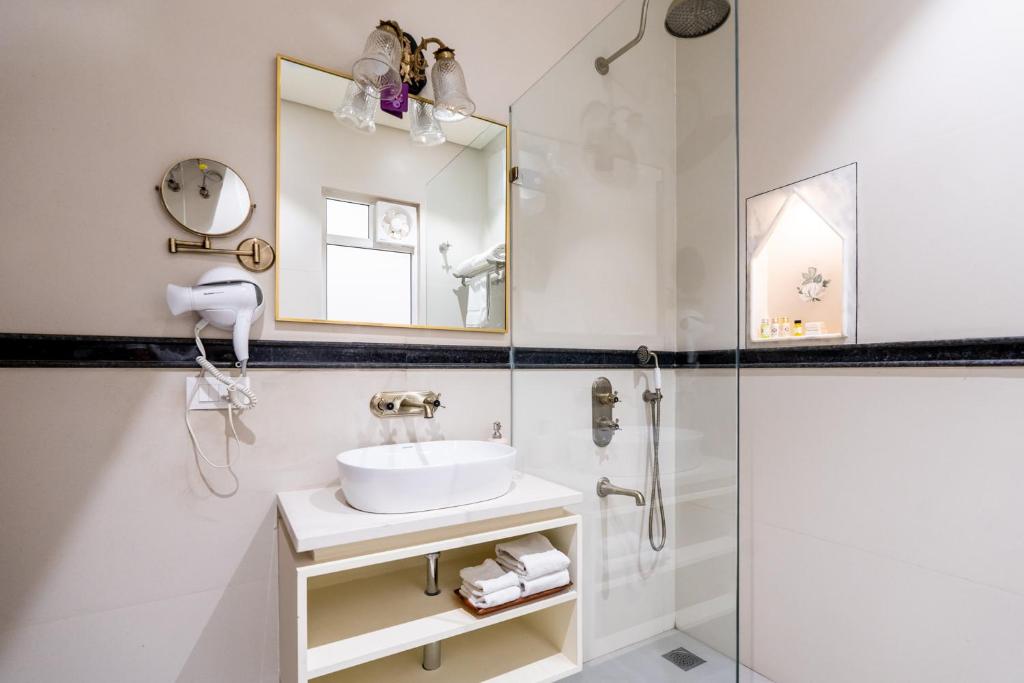 a bathroom with a sink and a shower at Dera Jaipur Homestay in Jaipur