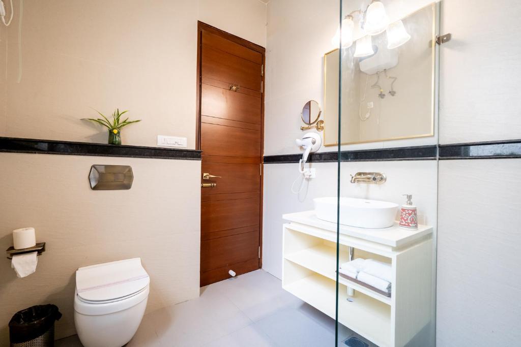 a bathroom with a toilet and a sink at Dera Jaipur Homestay in Jaipur