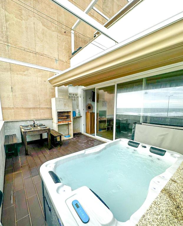 a large bathroom with a large tub in a room at MARESIA APART T0 - Praia do Furadouro in Ovar