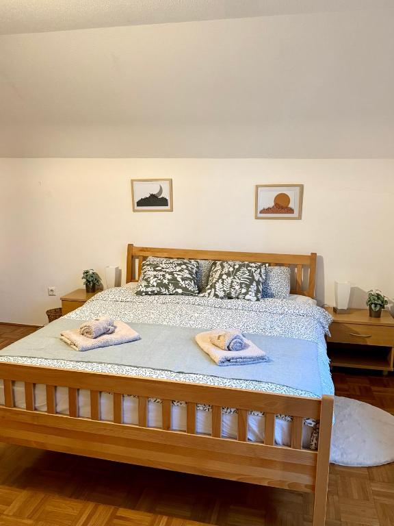 a bedroom with a bed with towels on it at Katja Cottage in Bohinjska Bela