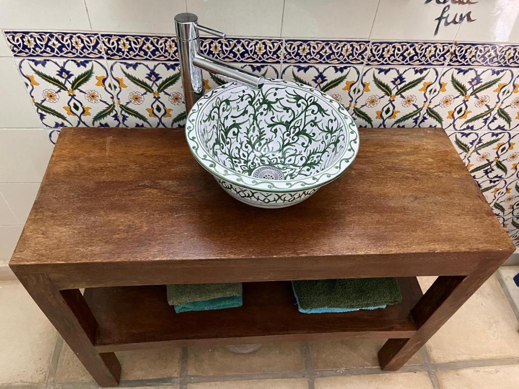 a bowl sitting on top of a wooden table at RESIDENCE DAR YASMINa in Mezraya