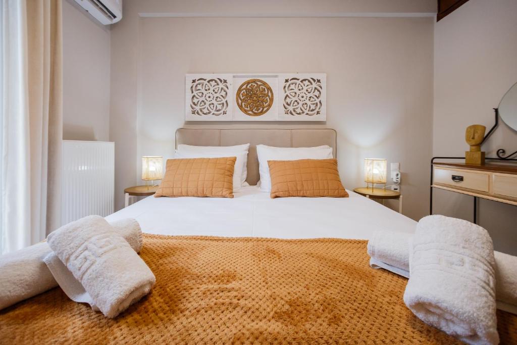a bedroom with a large white bed with towels on it at La casa sull' isola in Zakynthos Town