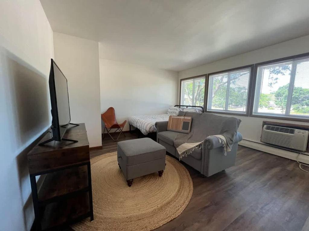 a living room with a couch and a tv at Liberty Valley Short Term Rental - 29 in Madison