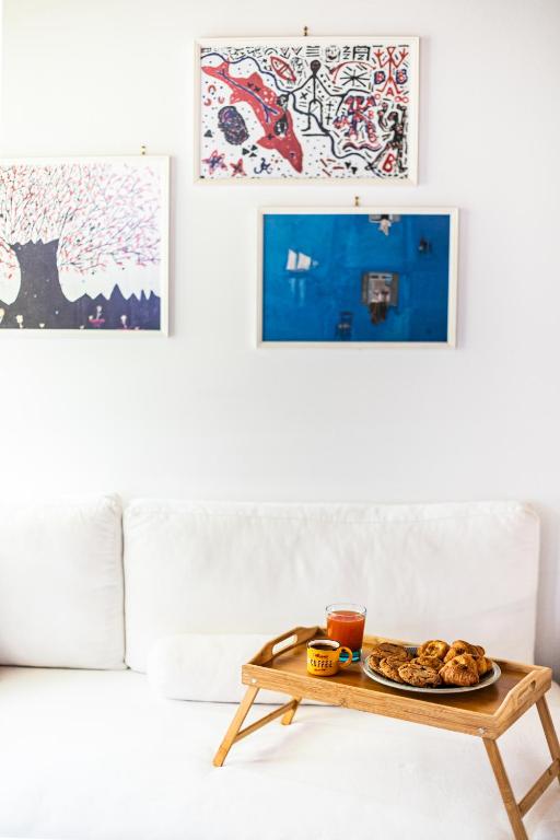 a coffee table with a plate of food on a couch at Rock Solid Stone House - Chora Samothraki in Samothraki