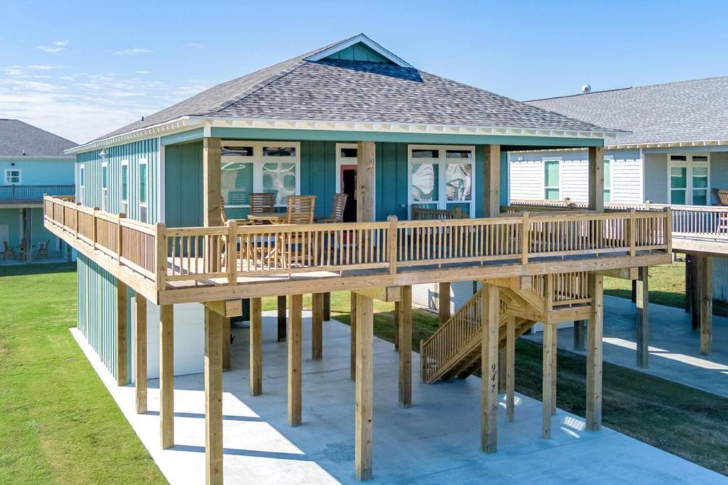 a house with a large deck on the water at 3 Bdr 3 Bth King Bed No Fees in Bolivar Peninsula