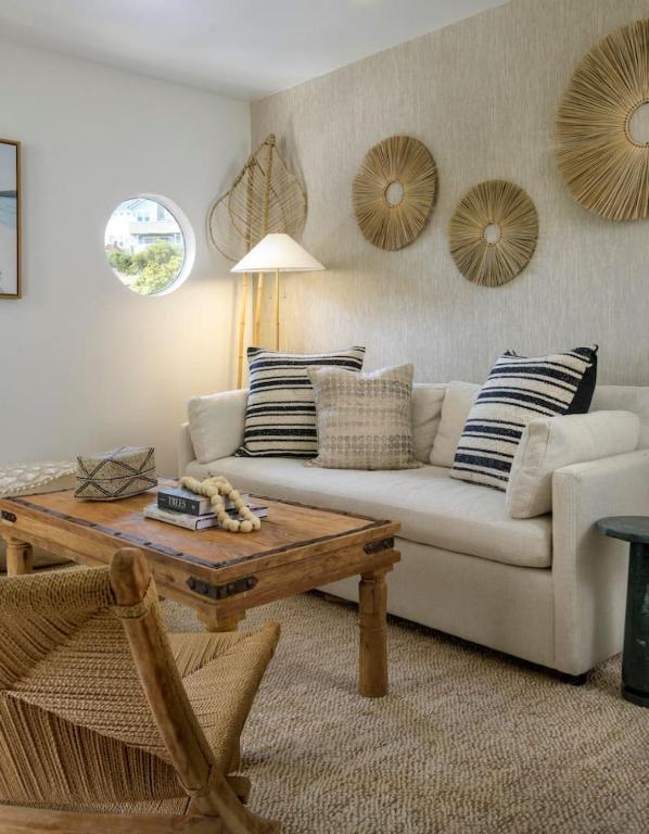 a living room with a couch and a coffee table at Private Balcony and Coastal Escape in Summerland