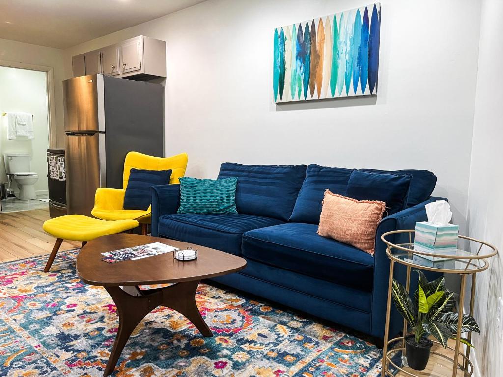 a living room with a blue couch and a table at The True The Archive Lofts in Marion