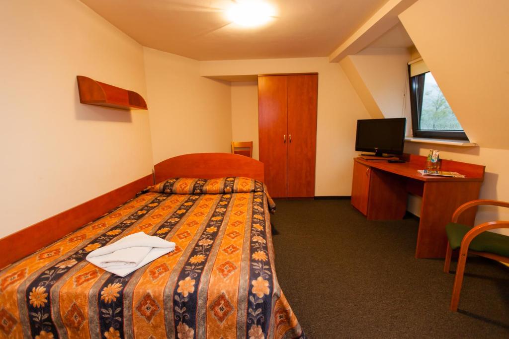 Postel nebo postele na pokoji v ubytování Geovita Wisła
