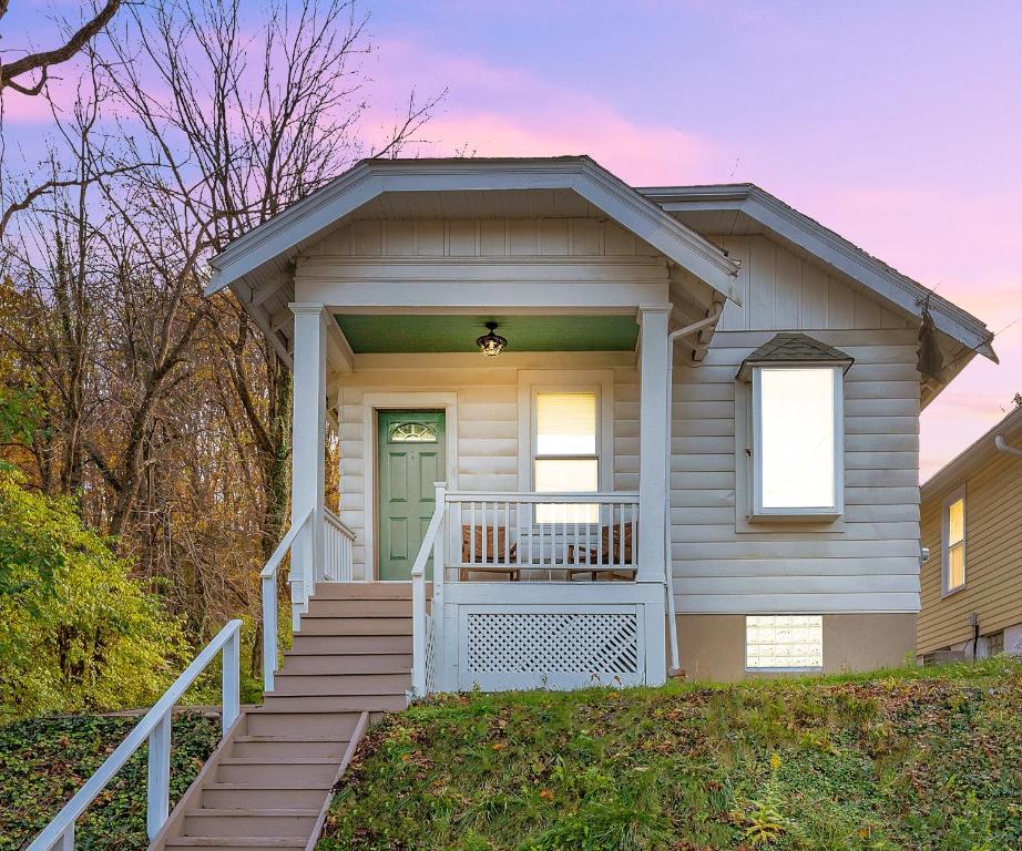 a house with a staircase leading to the front door at Cozy Cottage in the Heart of Hyde Park home in Cincinnati