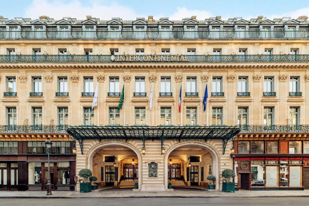 a large building with two flags in front of it at InterContinental Paris Le Grand by IHG in Paris