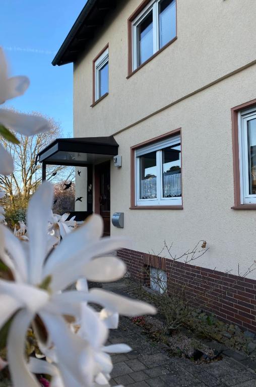 a house with a white flower in front of it at Ferienwohnung an der Warte in Waldeck