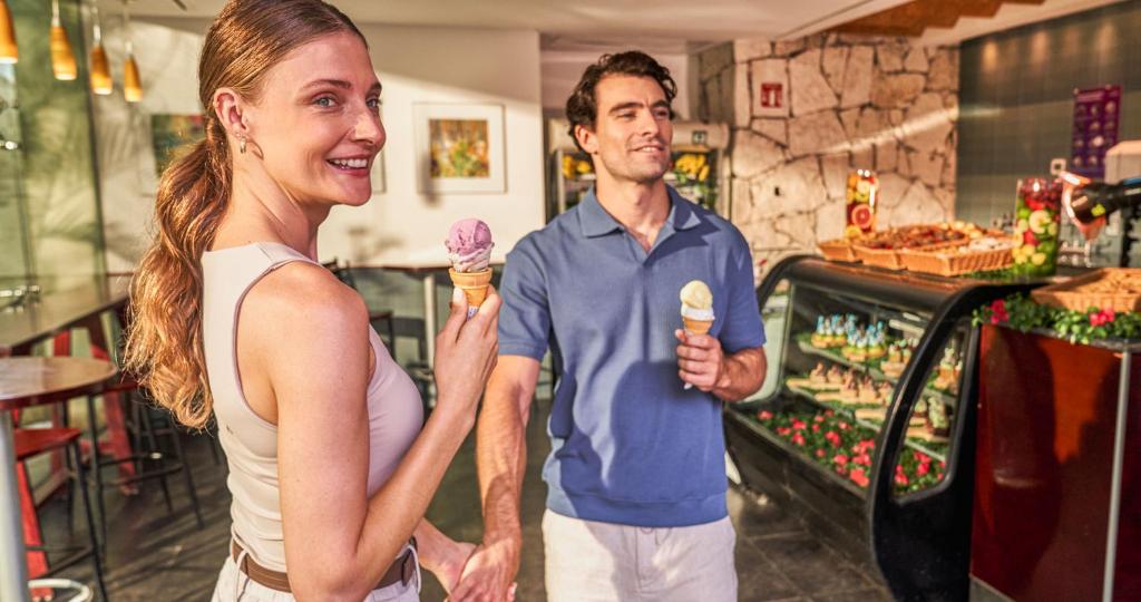 a man and a woman holding an ice cream cone at Grand Park Royal Cozumel - All Inclusive in Cozumel