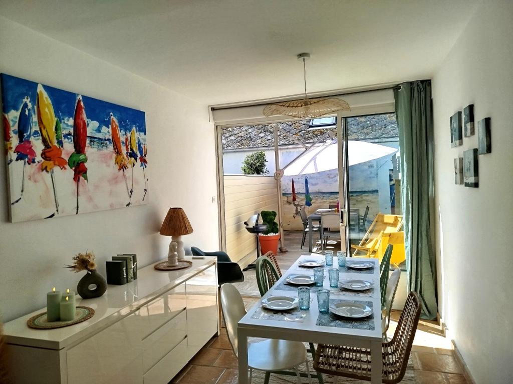 une salle à manger avec une table et quelques chaises dans l'établissement La plage en toile de fond!, à Trouville-sur-Mer
