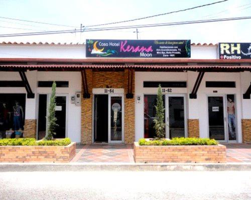 a building with a sign on the front of it at Hotel kerana moon in Puerto Boyacá
