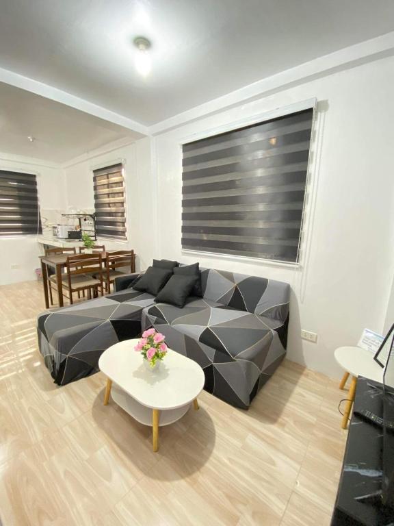 a living room with a couch and a table at Cabuhat Duco Lodge 31 in Tanza