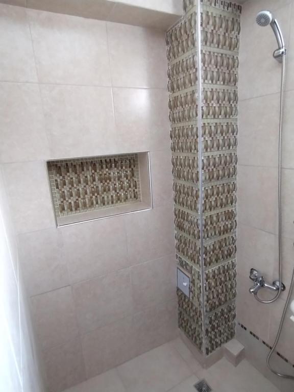 a bathroom with a shower with a glass door at Pleno centro con cochera in San Salvador de Jujuy
