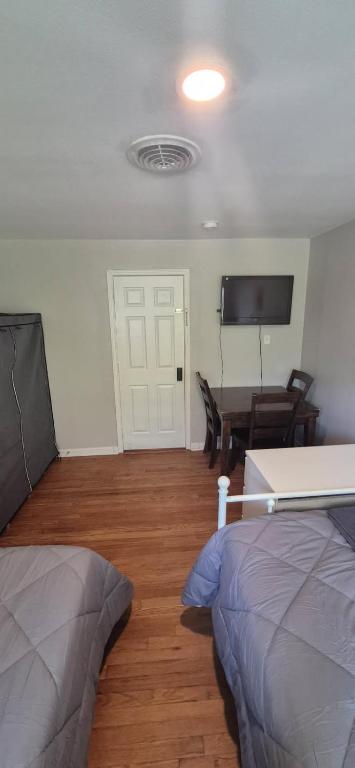 a room with two beds and a table and a television at Everything Bigger in texas in Houston