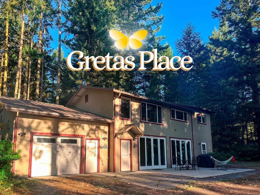 a building with a sign that readsctrias place at Sq Gretas Place in Sequim