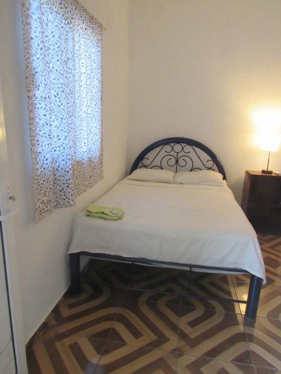a bed in a room with a window and a bed sidx sidx sidx at surf la bamba in Dolores Miramar