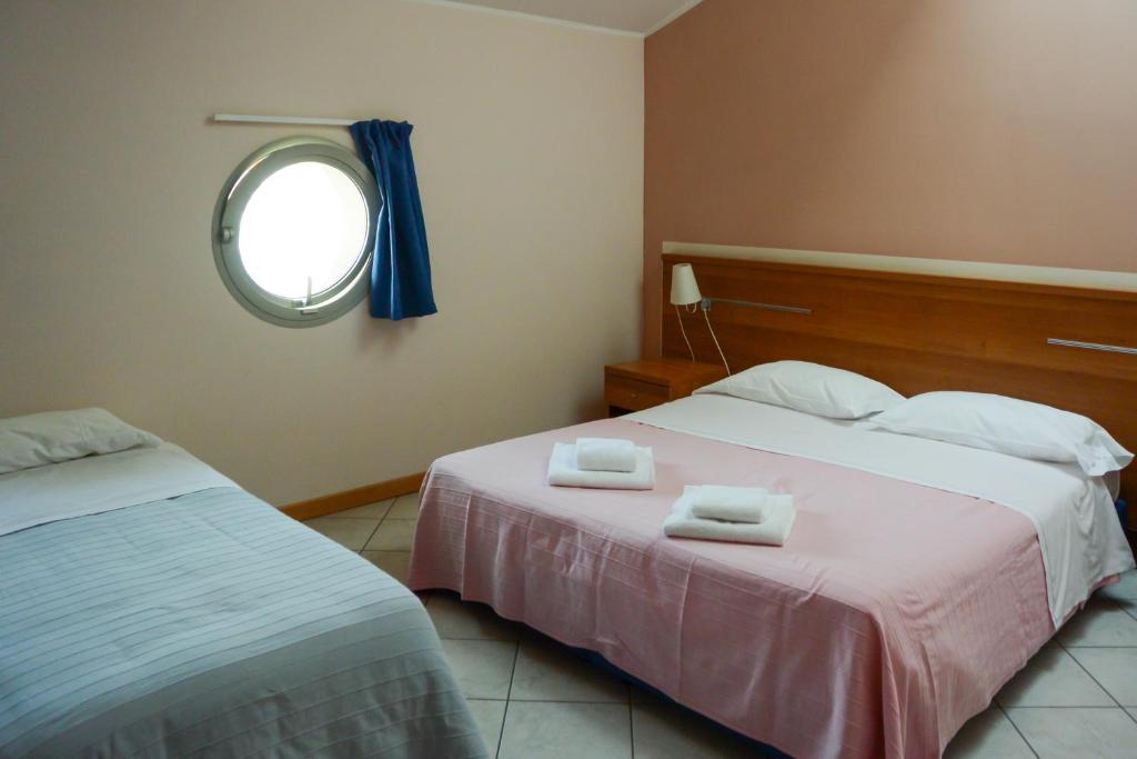 Postel nebo postele na pokoji v ubytování Albergo Meublè Abatjour