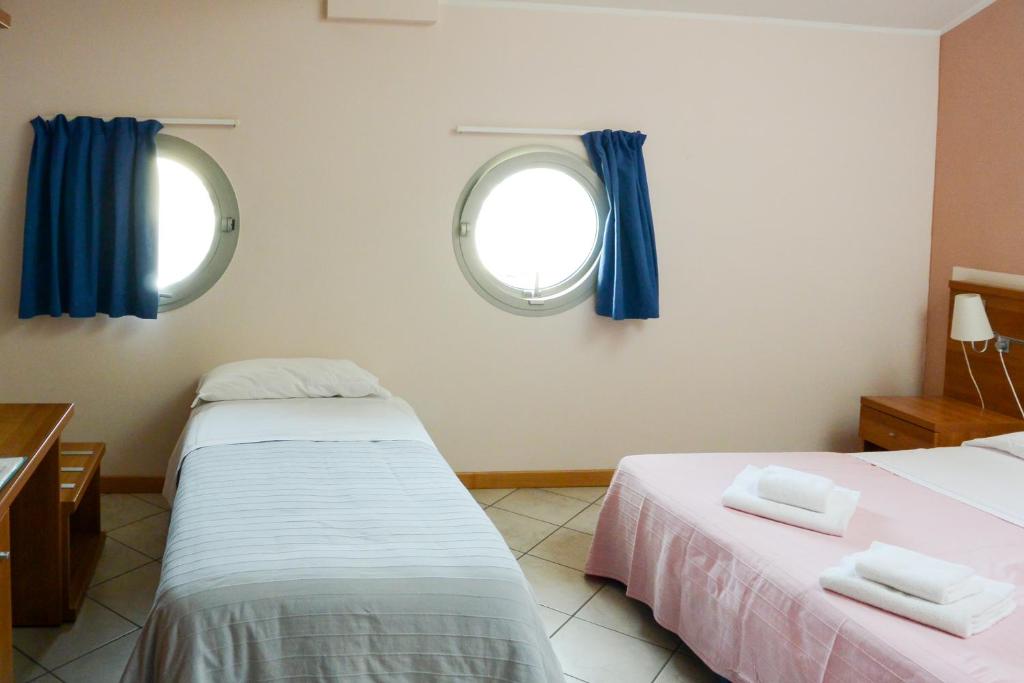 Postel nebo postele na pokoji v ubytování Albergo Meublè Abatjour