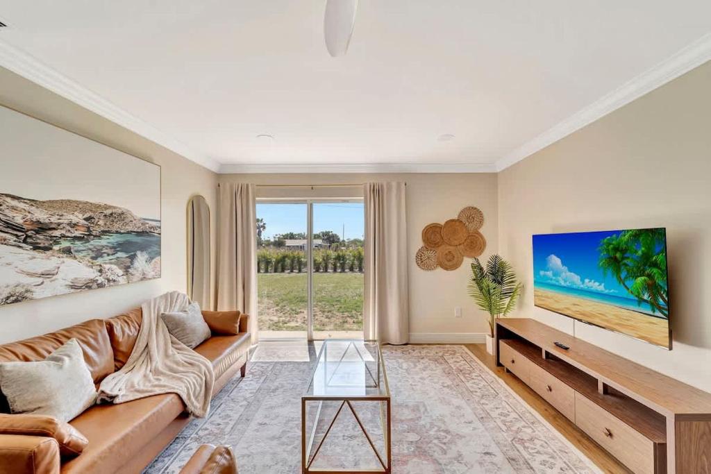 a living room with a couch and a table at Sunrise Suite Central to I75 airport & downtown in Punta Gorda