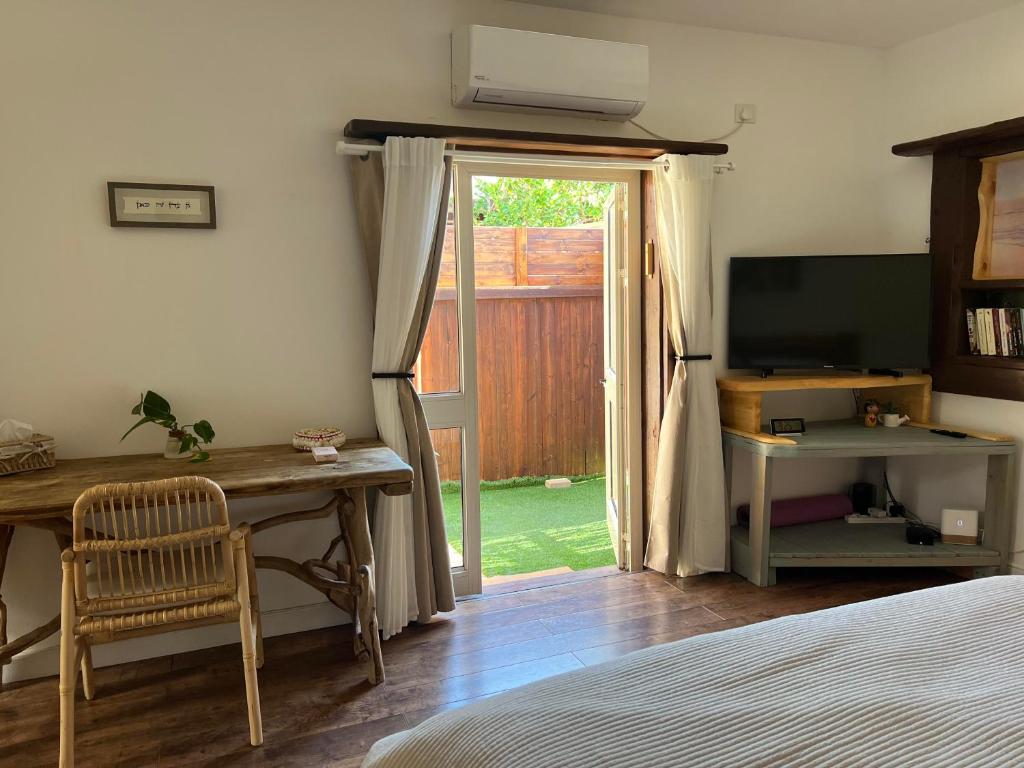 a bedroom with a desk and a sliding glass door at Unique Suite In Eilat in Eilat