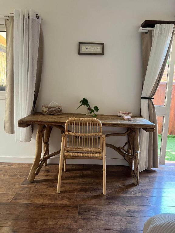 a wooden table with a chair in a room at Unique Suite In Eilat in Eilat
