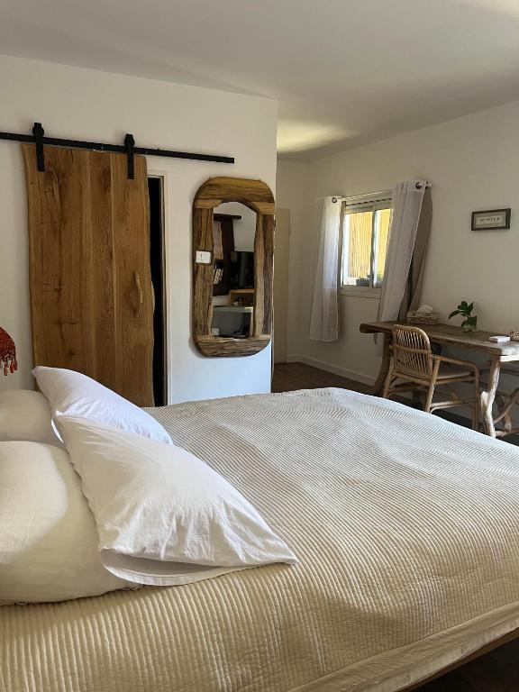 a bedroom with a large bed with white pillows at Unique Suite In Eilat in Eilat