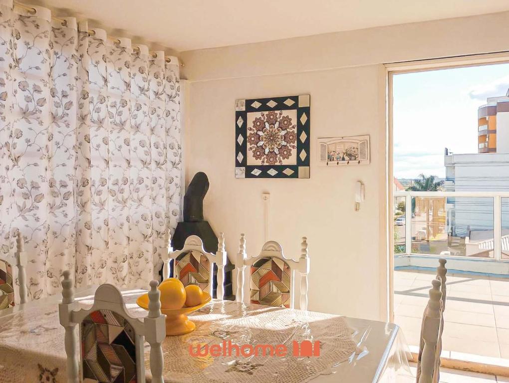 a dining room with a table and a window at Cobertura com Vista e Conforto no RS in Santo Ângelo